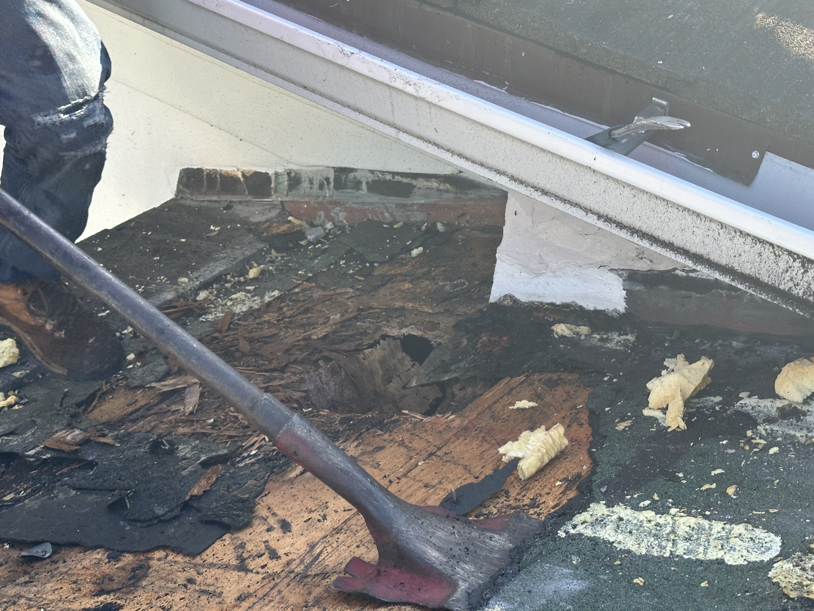 Deck rot and a hole in the plywood where roof flashing failed, exposed during repair
